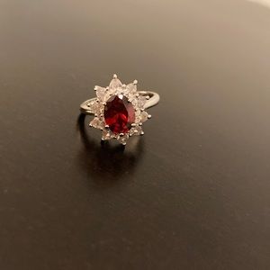 Artificial ruby and CZ starburst halo ring.